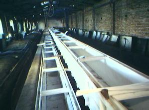 Pickling-line tanks and equipment inside an industrial workshop